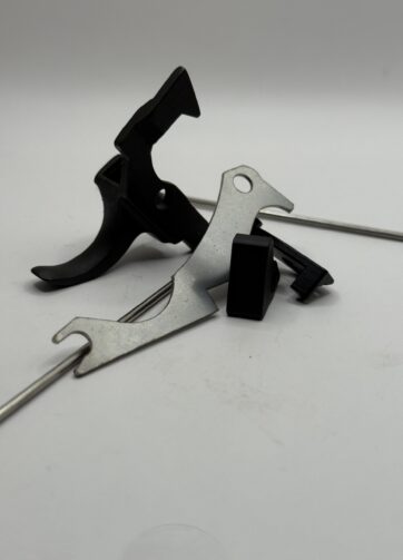 AK forced reset kit components — retainer plate, trigger cam, trip bars, pins