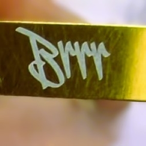 Close-up of Brrr engraving on gold anodized Gunetic Innovations V4 Slip Trip