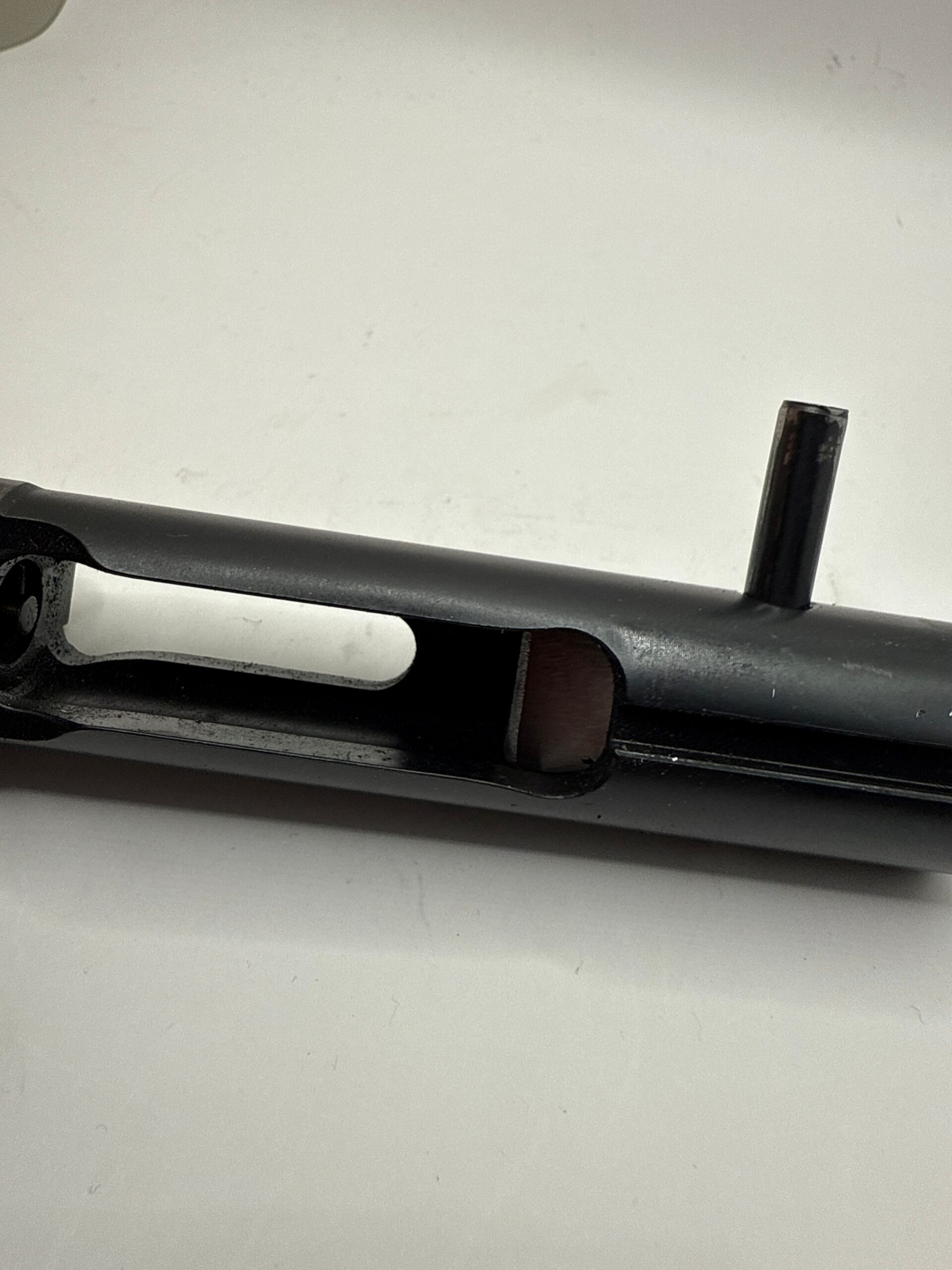 This is a NFA 9mm BCG. You will see the pin towards the right of the BCG, You must pull the pin, to gain access to the to BCG weight in the photo on the left. If you look below, you'll see the BCG and Weight before they've. been unmated. make the cut, reassemble everything. and you are ready to rock. as far as the 
BCG concerned.